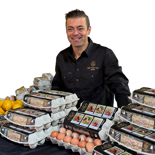 Erhan Boduk, owner of Bee Point Hill Farm, at the market stall with egg cartons